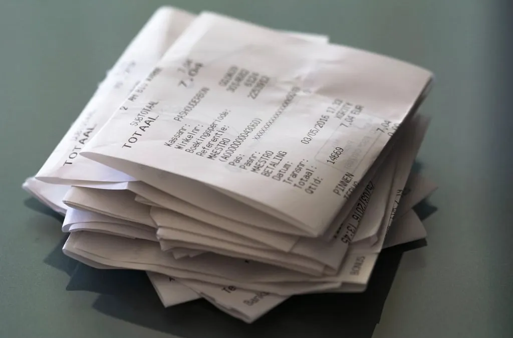 A stack of folded paper receipts on a table