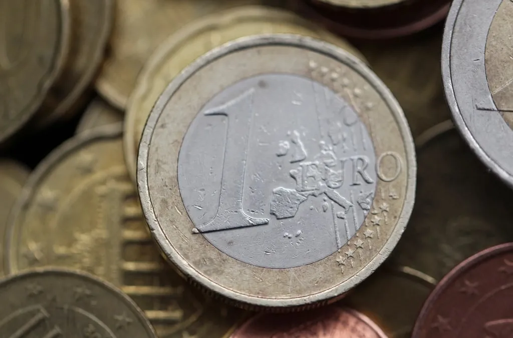 Close view of a one euro coin lying among other euro coins