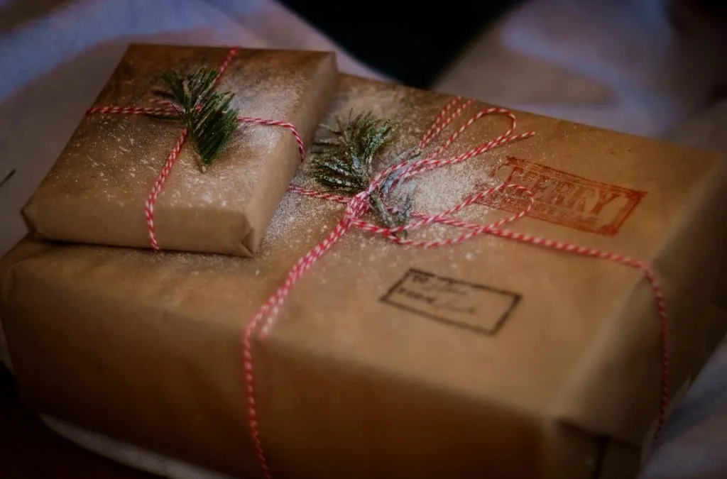 Two parcels wrapped in brown paper and tied with red and white string