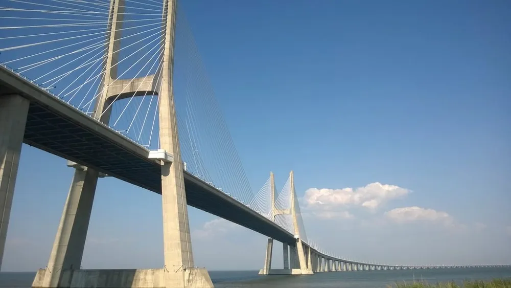 The Vasco da Gama cable-stayed bridge in Lisbon under a blue sky
