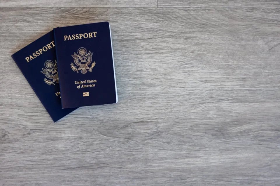 Two U.S. passports on a wooden table